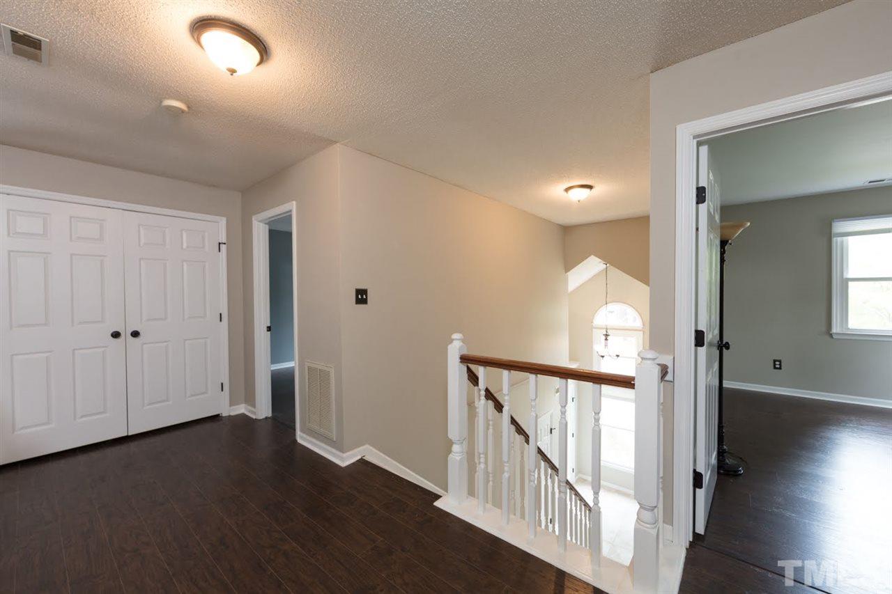 4713 Tolley Court Raleigh, NC 27616 - Photo 12 of 28 wooden floor in a hall with a window