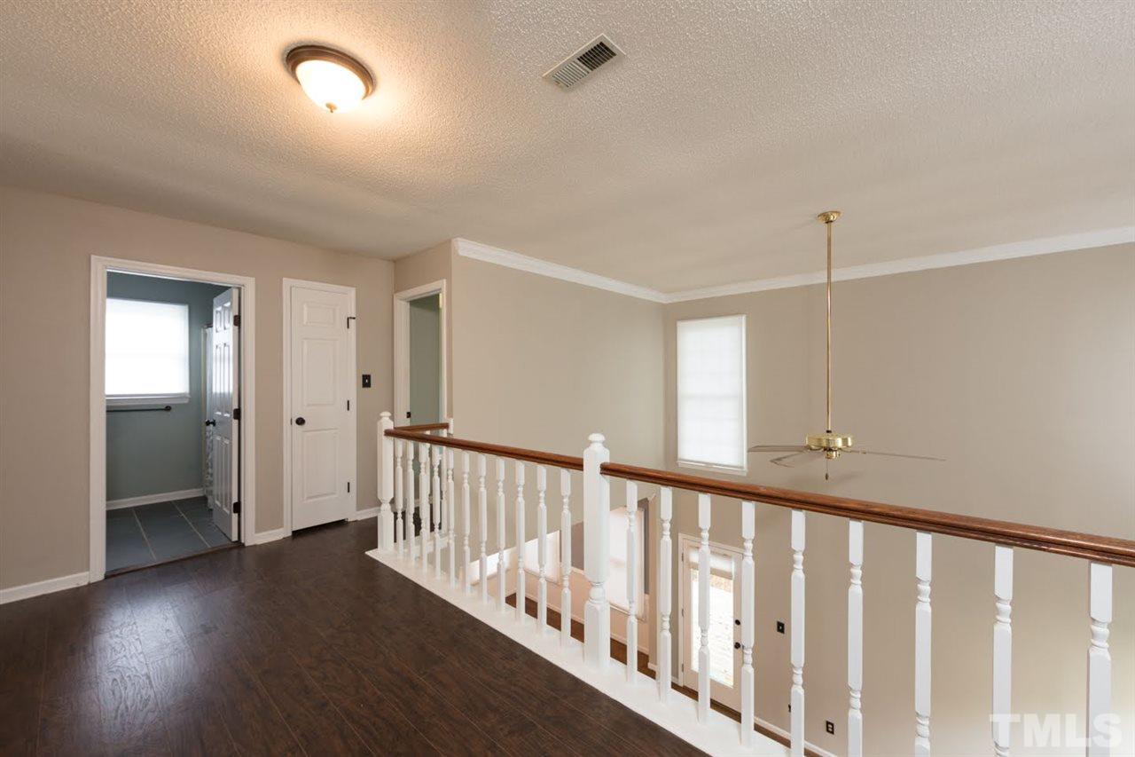 4713 Tolley Court Raleigh, NC 27616 - Photo 14 of 28 a view of a hallway with wooden floor and windows