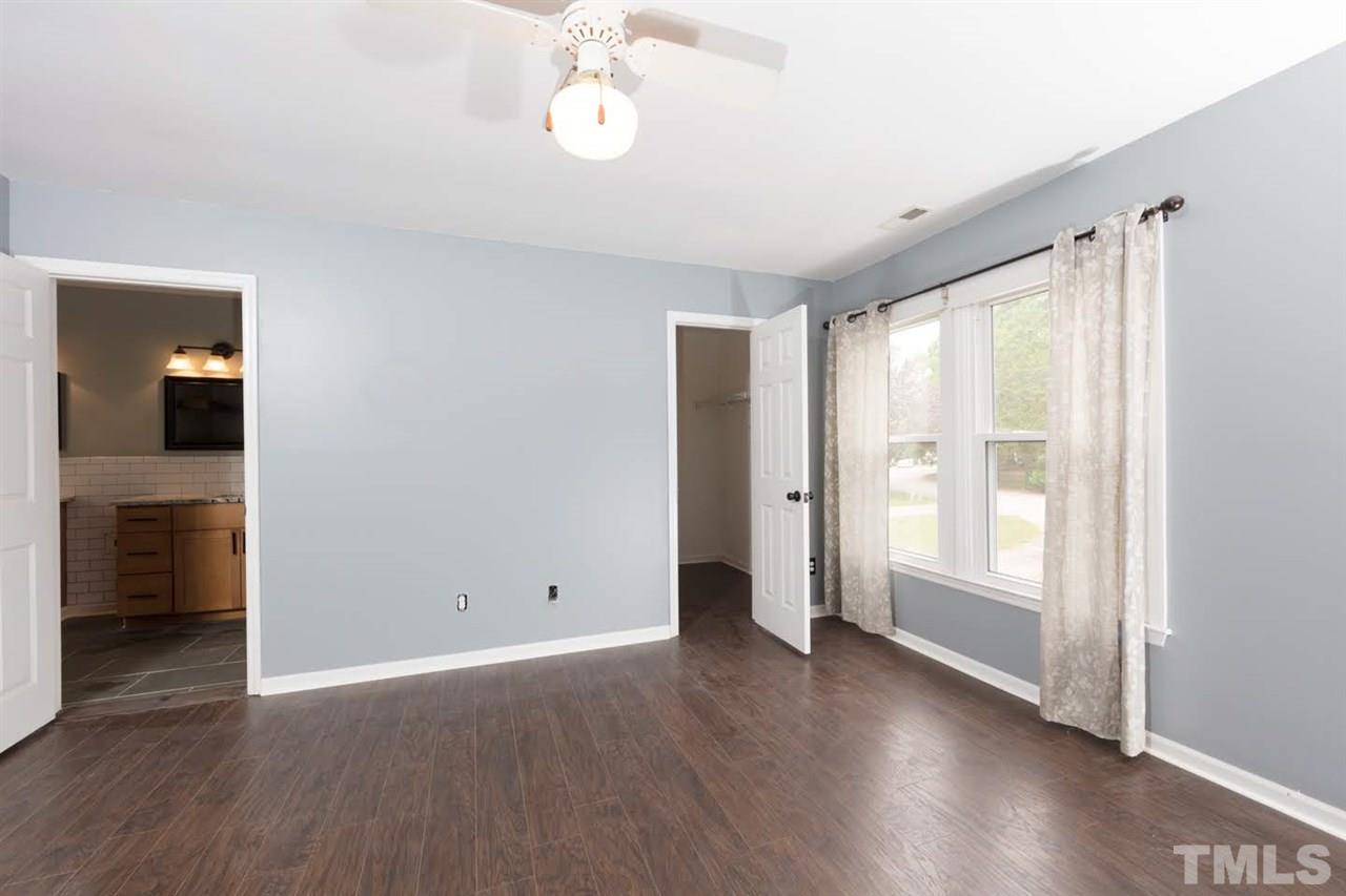 4713 Tolley Court Raleigh, NC 27616 - Photo 15 of 28 an empty room with wooden floor and windows