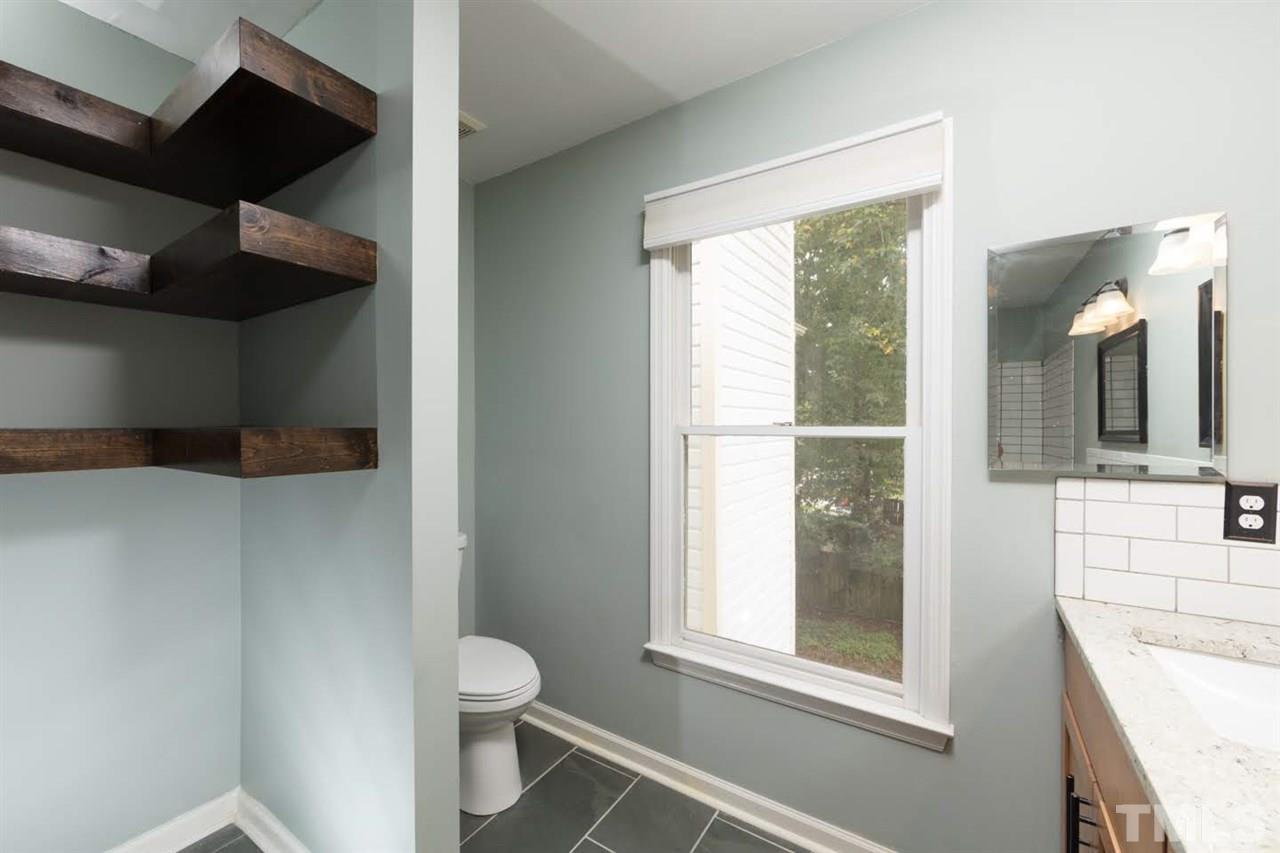4713 Tolley Court Raleigh, NC 27616 - Photo 18 of 28 a bathroom with a toilet sink and mirror