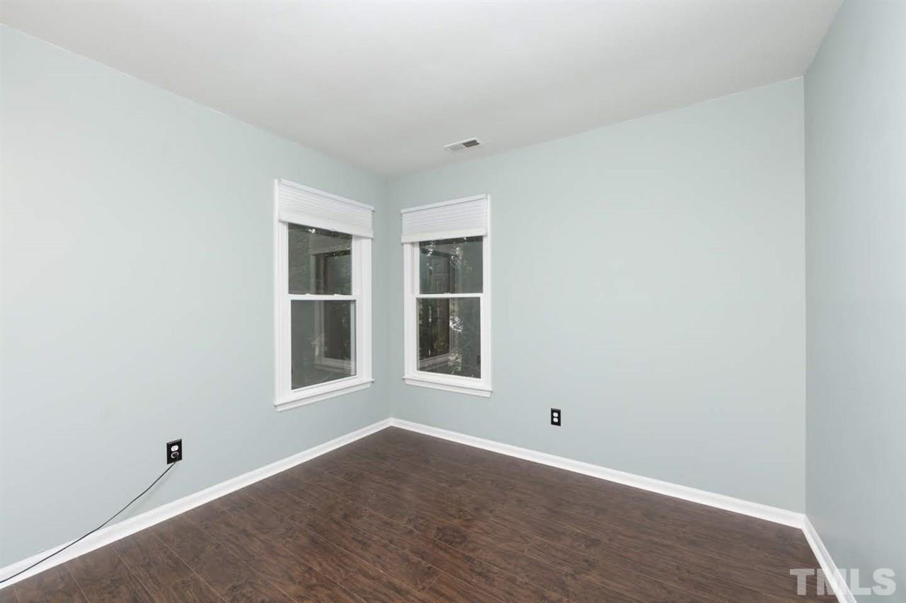4713 Tolley Court Raleigh, NC 27616 - Photo 20 of 28 a view of an empty room with wooden floor and a window