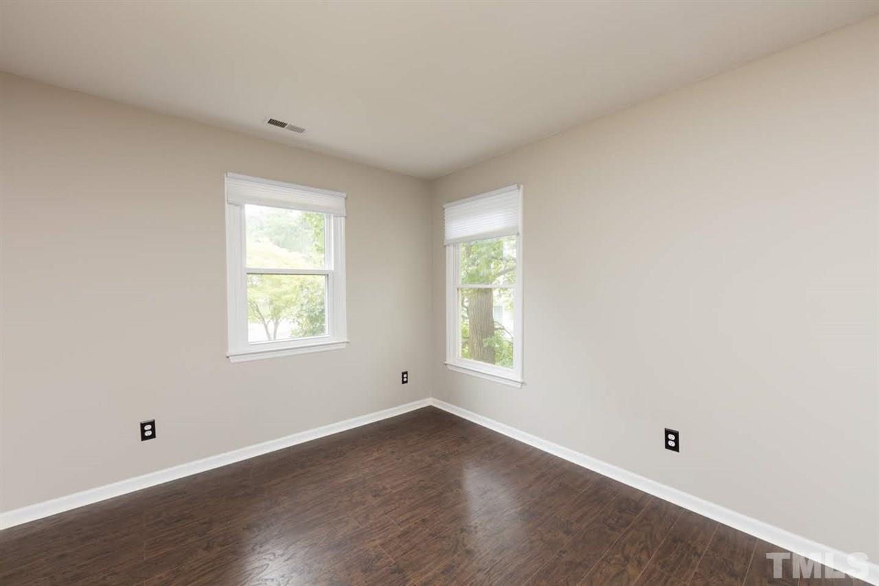 4713 Tolley Court Raleigh, NC 27616 - Photo 22 of 28 an empty room with wooden floor and windows