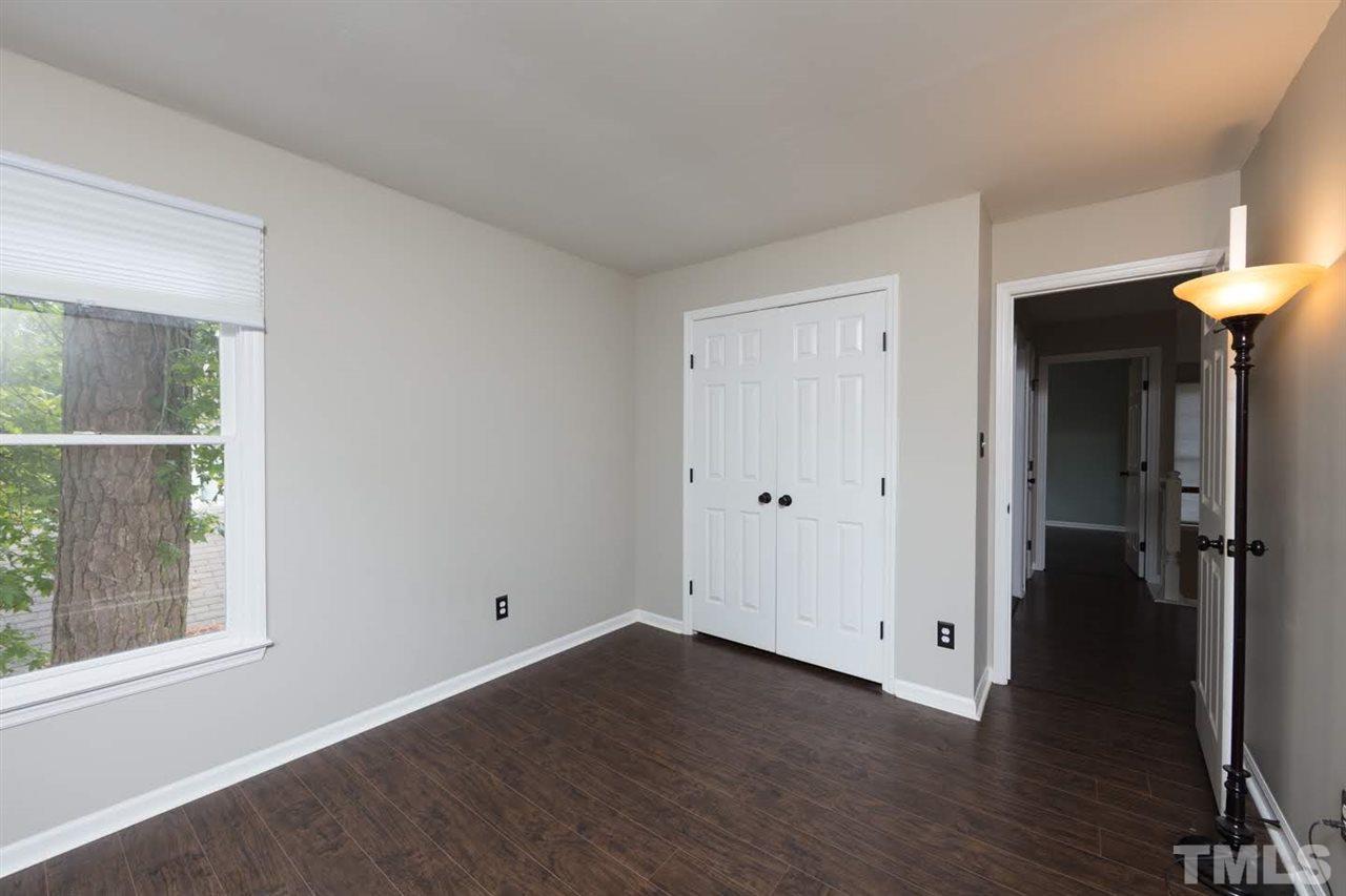 4713 Tolley Court Raleigh, NC 27616 - Photo 23 of 28 a view of an empty room with wooden floor and a window