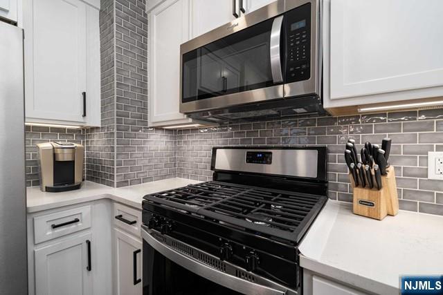 141 Park Avenue, Unit 8A East Rutherford, NJ 07073 - Photo 9 of 22 a stove top oven sitting inside of a kitchen