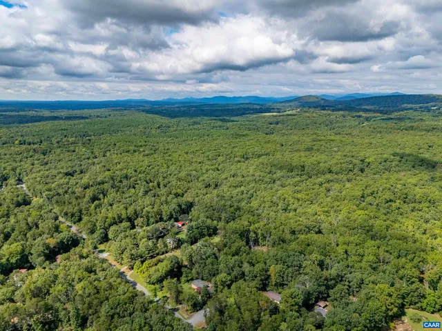 a view of a big yard with lots of green space
