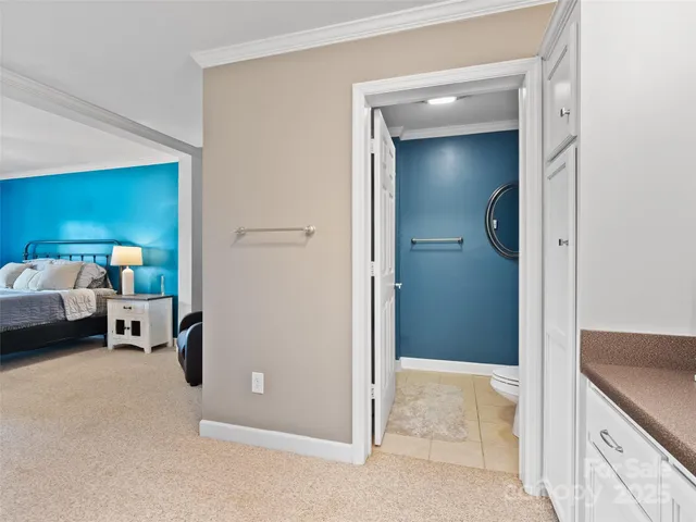 a bedroom with a large bed and a ceiling fan