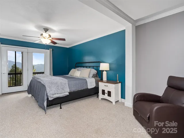 a bedroom with a large bed and a chandelier
