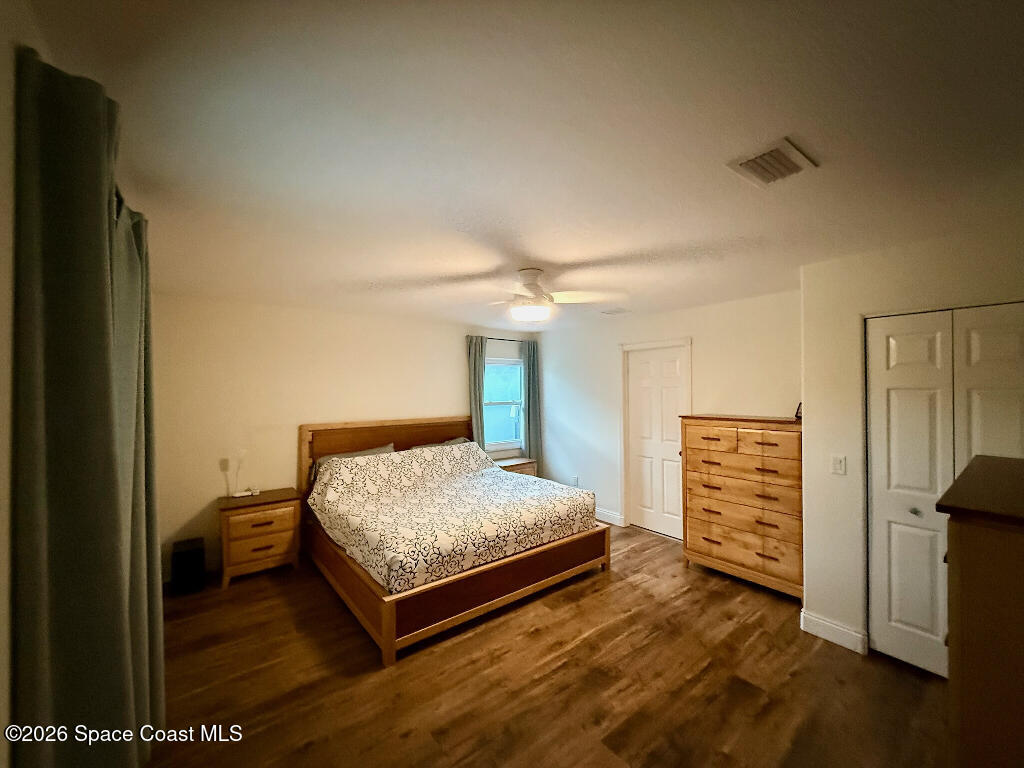 9010 Central Avenue Sebastian, FL 32976 - Photo 13 of 18 a bedroom with a bed and dresser with mirror