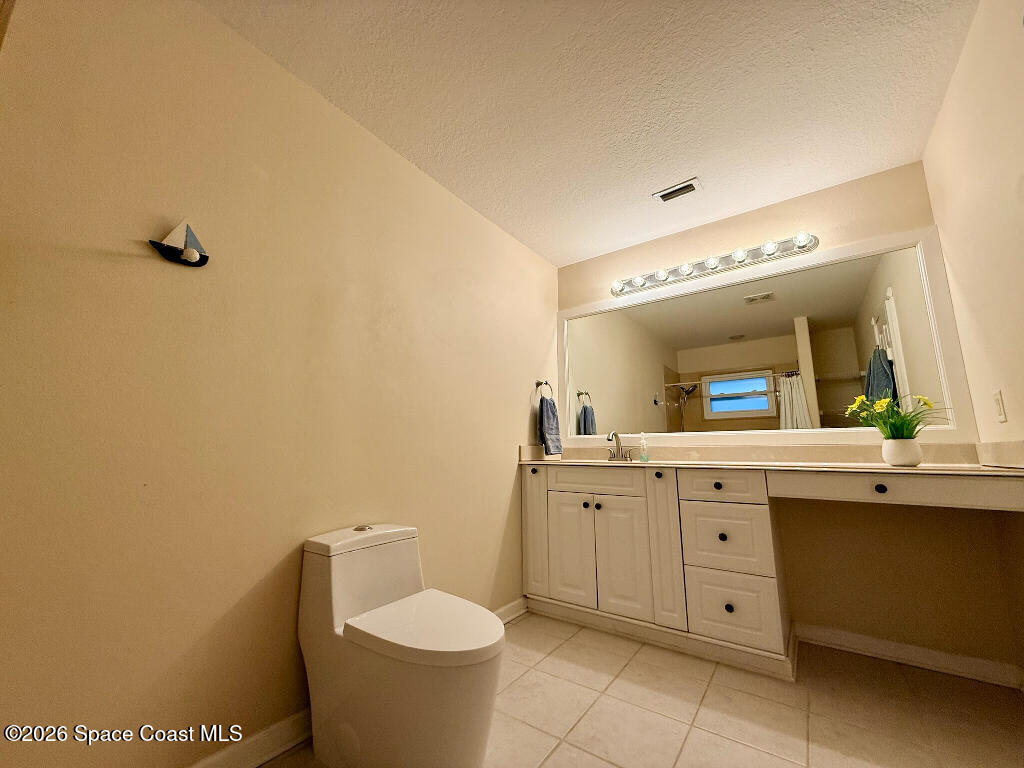 9010 Central Avenue Sebastian, FL 32976 - Photo 15 of 18 a bathroom with a toilet sink and mirror