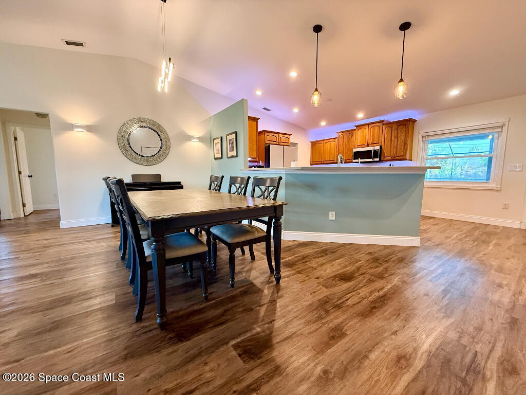 9010 Central Avenue Sebastian, FL 32976 - Photo 10 of 18 a view of a dining room with furniture and wooden floor