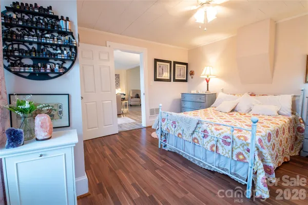 a bedroom with a bed table and window