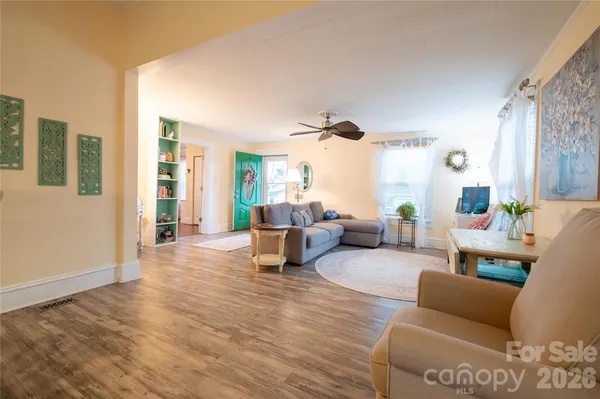 a living room with furniture and wooden floor