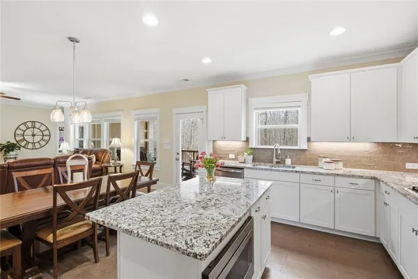 a kitchen with stainless steel appliances granite countertop a refrigerator and microwave