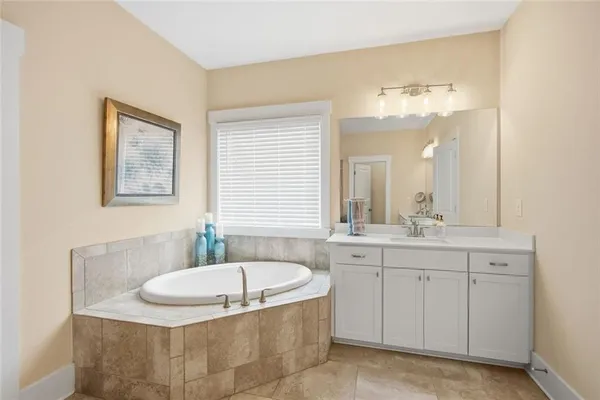 a en suite bathroom with a shower sink and mirror
