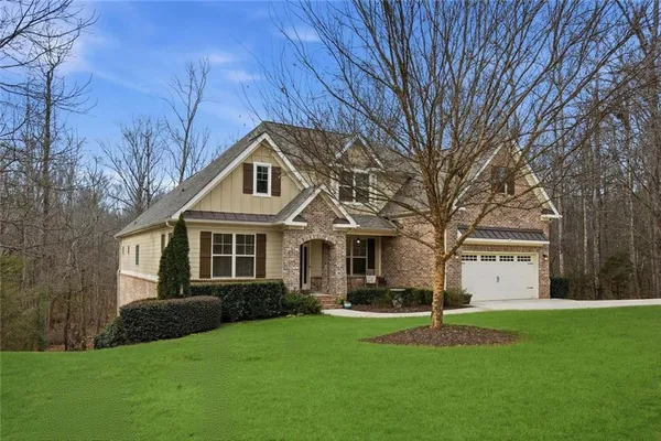 a backyard of a house with a yard and outdoor seating