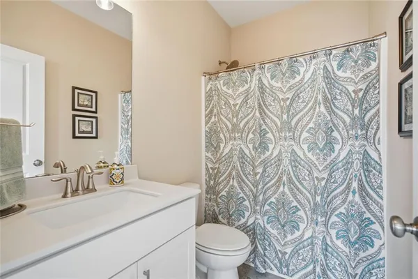 a living room with furniture white walls and a chandelier