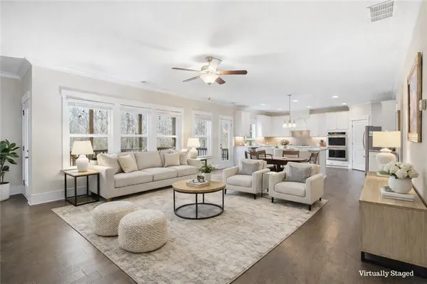 a living room with furniture and wooden floor