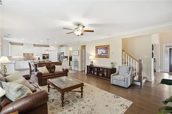 a living room with furniture a fireplace and a large window