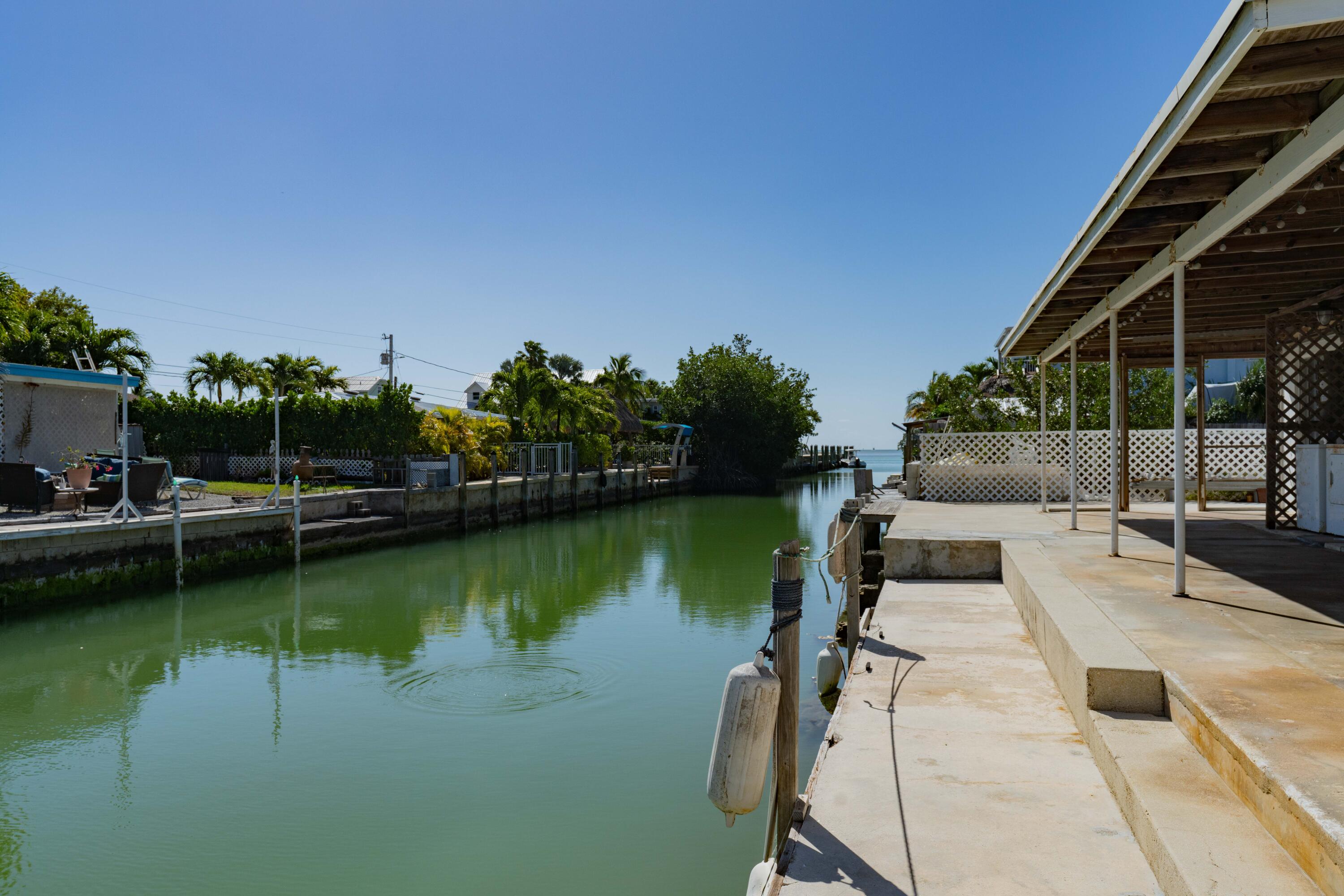 798 96th Street Marathon, FL 33050 - Photo 2 of 28 a view of a swimming pool with a patio and a yard