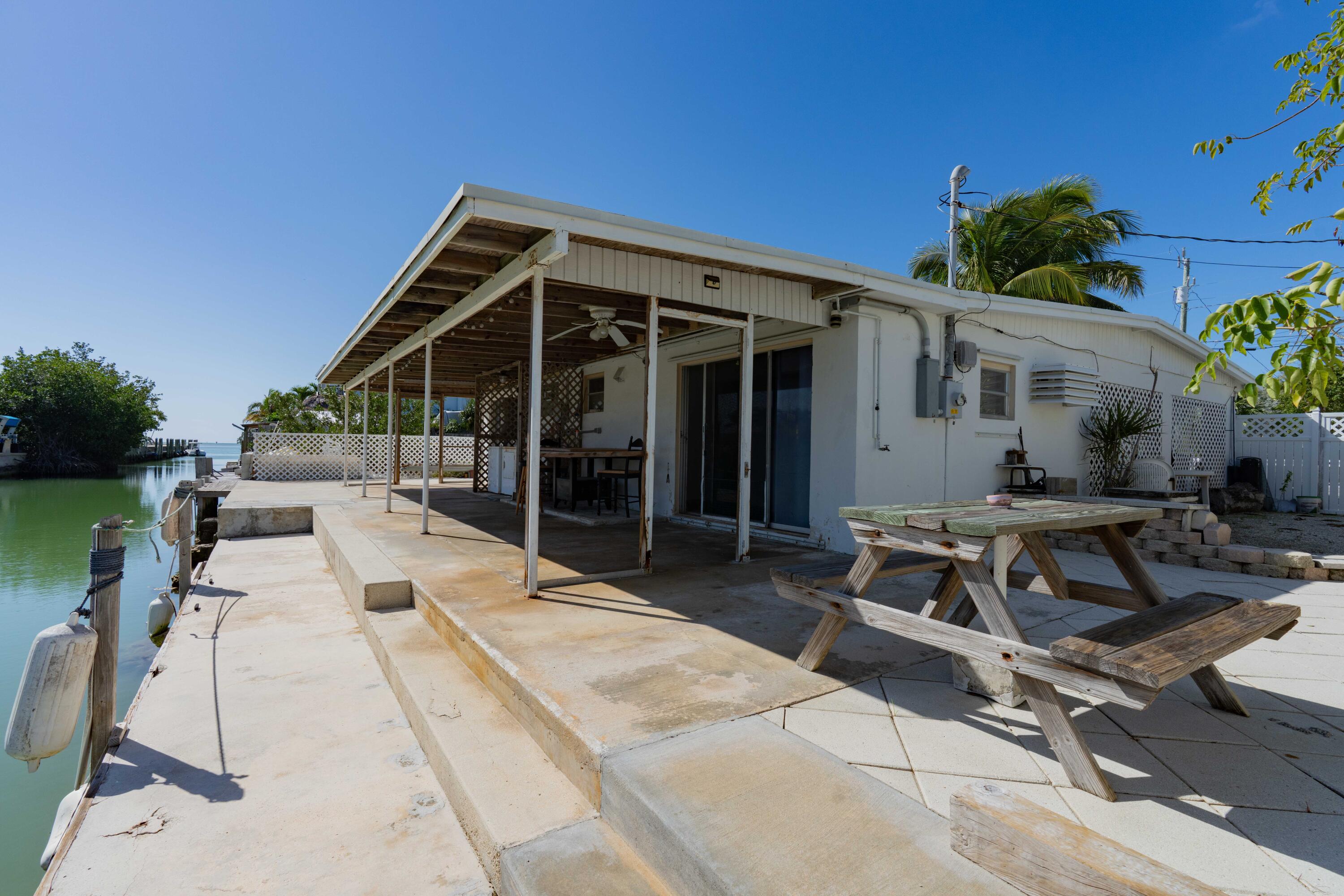 798 96th Street Marathon, FL 33050 - Photo 6 of 28 a view of backyard with a patio and outdoor seating