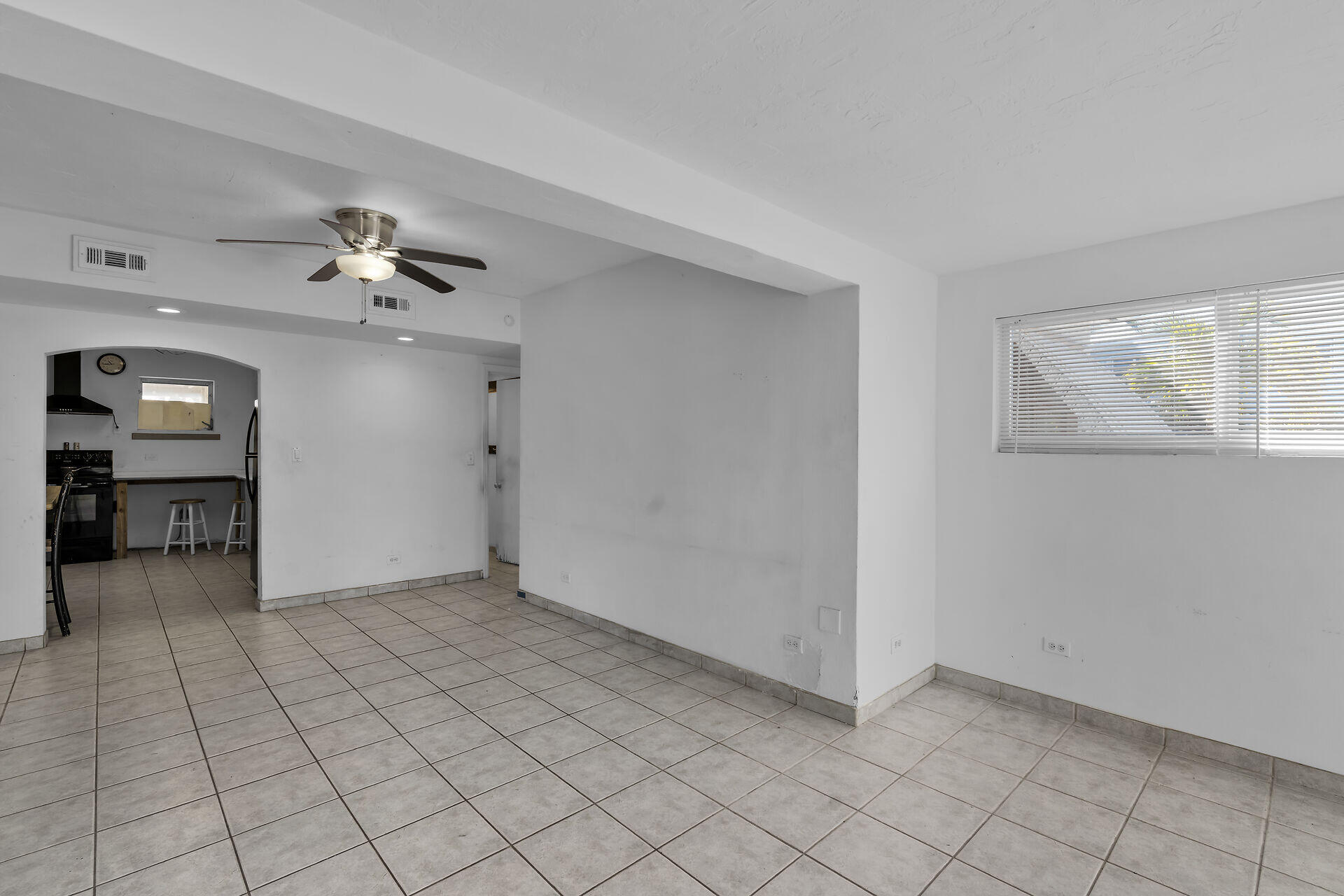 798 96th Street Marathon, FL 33050 - Photo 10 of 28 an empty room with chandelier fan and windows