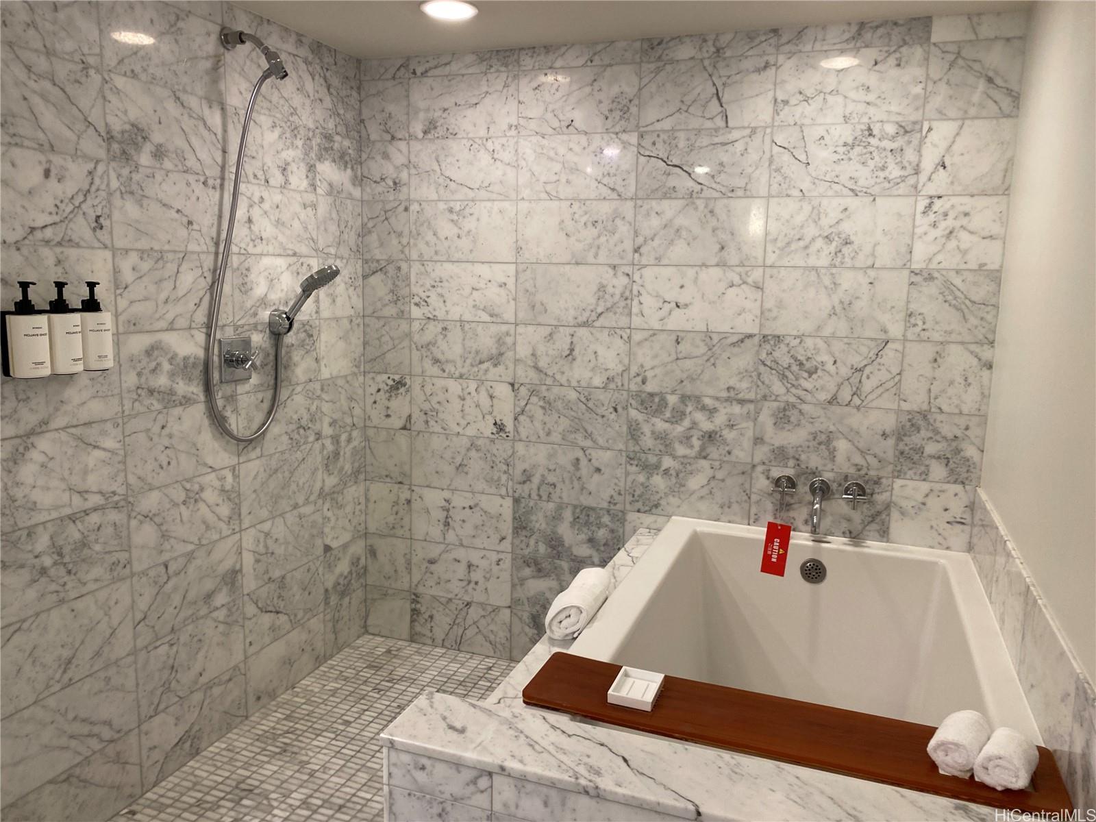 223 Saratoga Road, Unit 2316 Honolulu, HI 96815 - Photo 13 of 20 a bathroom with a bathtub and a shower