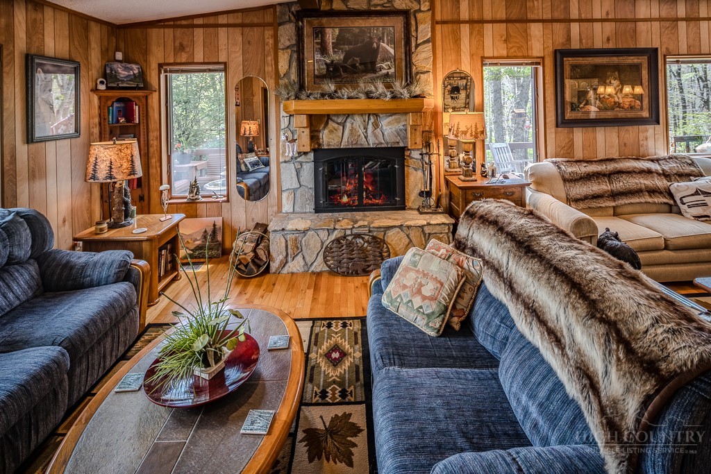 103-105 Upper Grouse Ridge Road Beech Mountain, NC 28604 - Photo 19 of 48 a living room with furniture and a fireplace