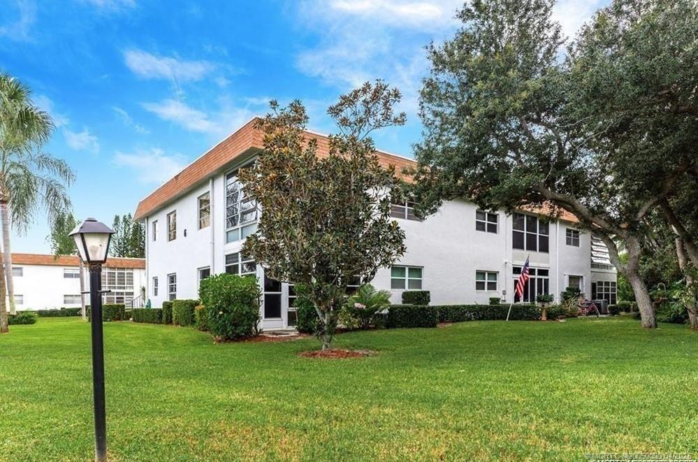 2950 Southeast Ocean Boulevard, Unit 66 Stuart, FL 34996 - Photo 2 of 18 a view of a house with a yard