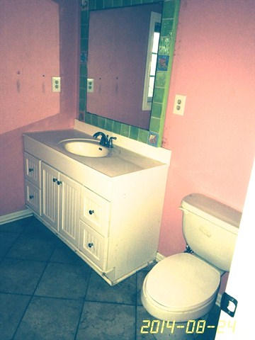 4233 Bob Sikes Road DeFuniak Springs, FL 32435 - Photo 3 of 5 a bathroom with a toilet a sink and a mirror