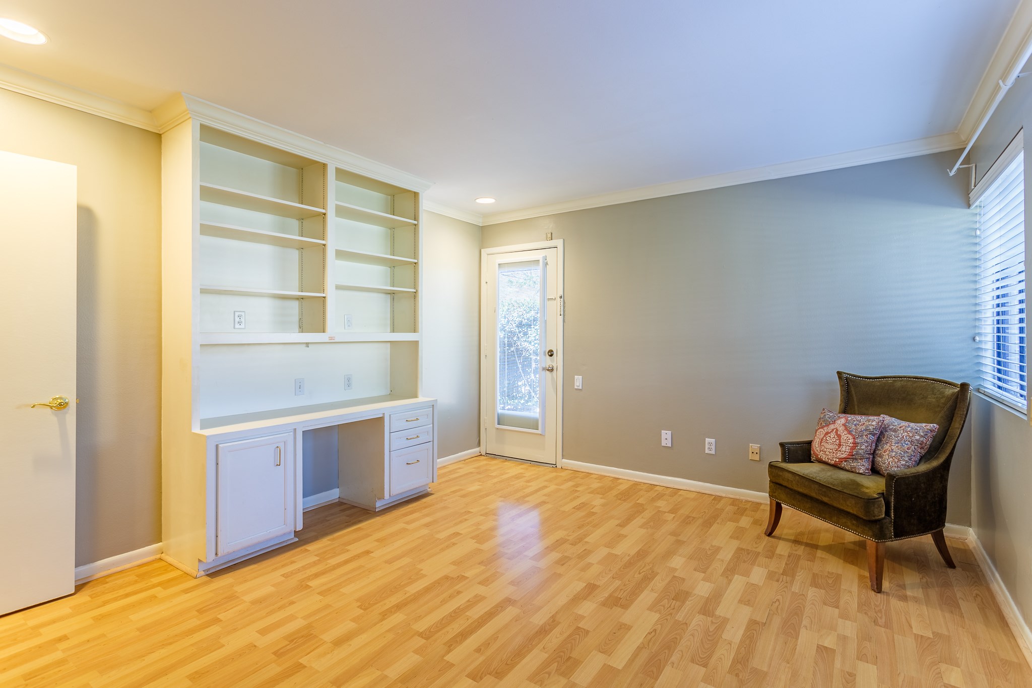 2349 Albans Road, Unit 1 Houston, TX 77005 - Photo 2 of 14 Living room with light wood flooring, built-in shelves. Ample natural light from large windows. Ideal for a home office or reading nook.