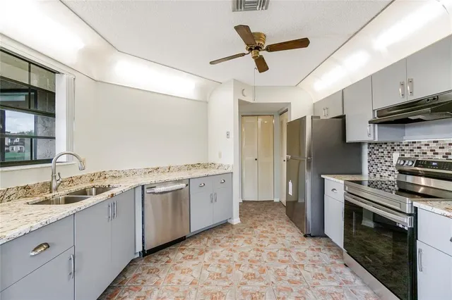 a kitchen with a sink stove and refrigerator