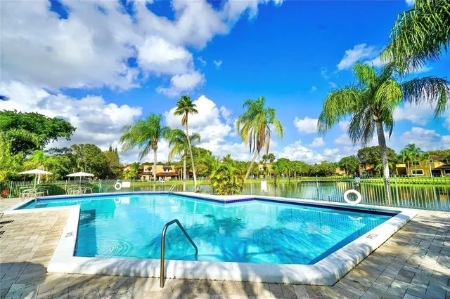 a view of a swimming pool with a table and chairs