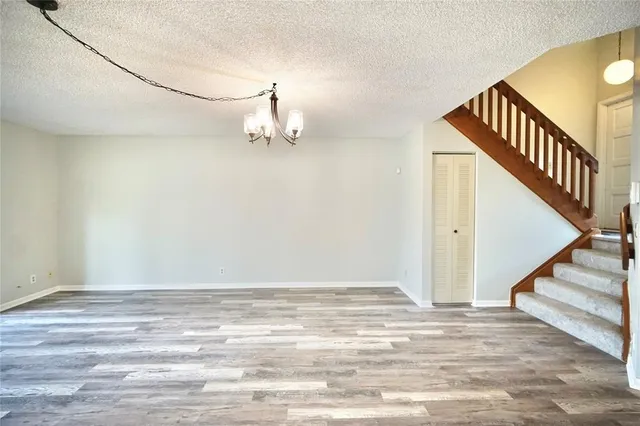 a view of a room with wooden floor