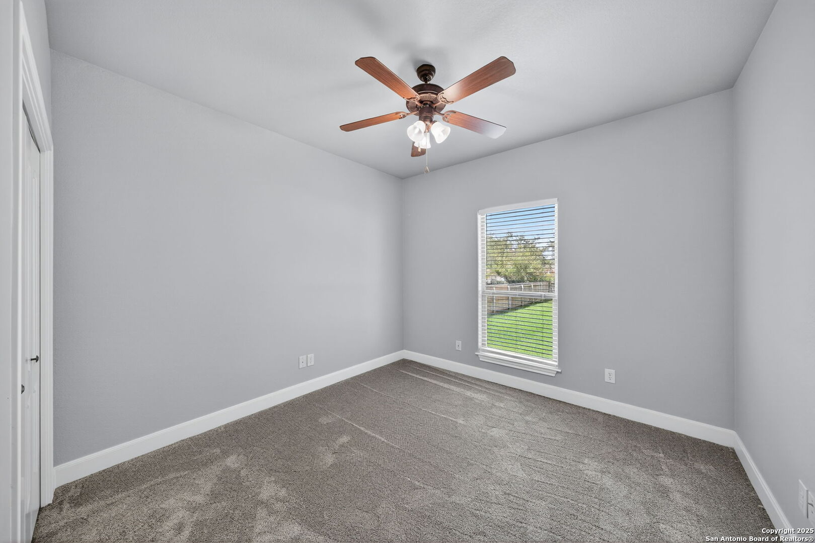 1626 Clover Ridge Pleasanton, TX 78064 - Photo 18 of 33 an empty room with windows and fan