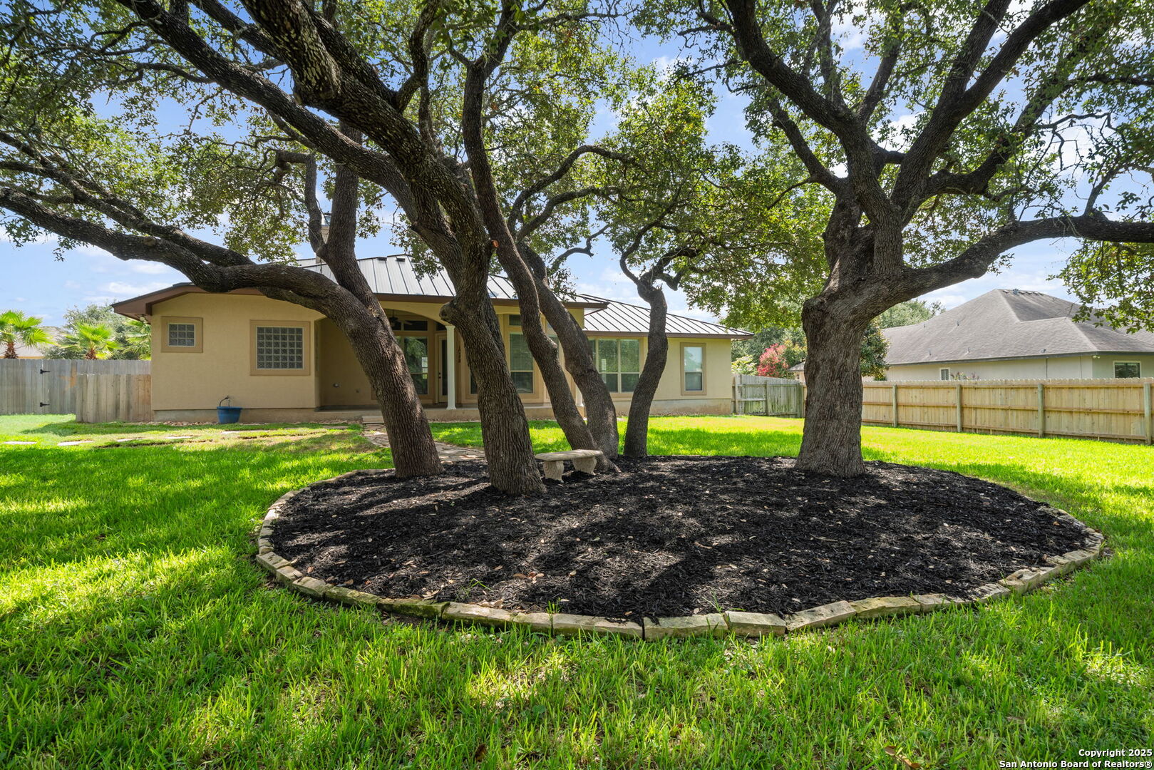 1626 Clover Ridge Pleasanton, TX 78064 - Photo 32 of 33 a view of a yard in front of a house with plants and large tree