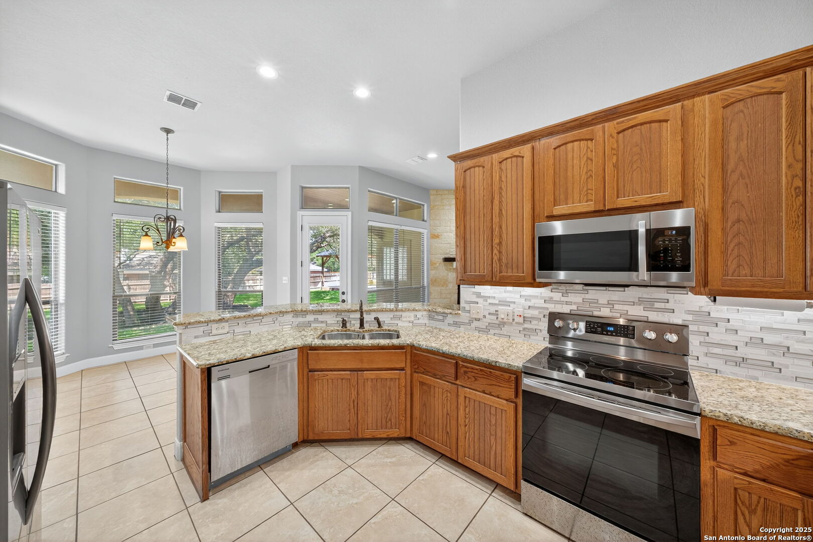 1626 Clover Ridge Pleasanton, TX 78064 - Photo 9 of 33 a kitchen with stainless steel appliances granite countertop a stove microwave and sink
