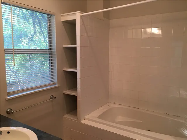 a bathroom with a bathtub and a shower