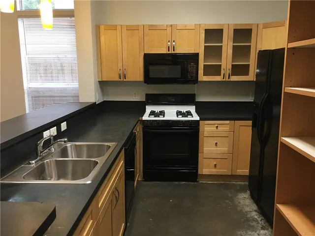 a kitchen that has a sink and a stove