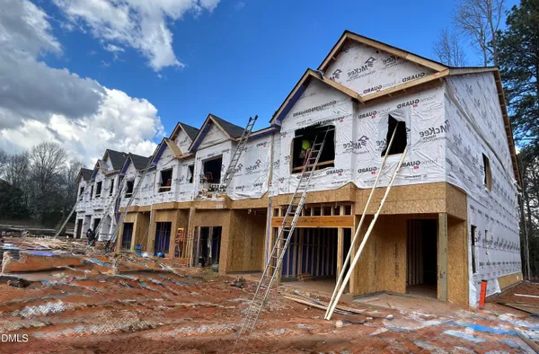 a view of a white house with large windows