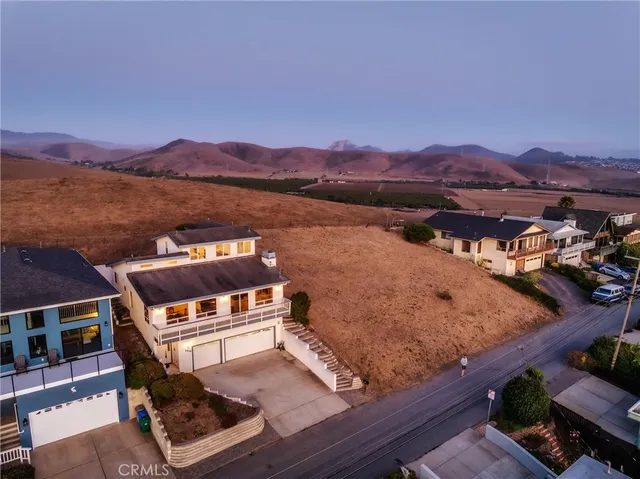 a view of a house with backyard porch and sitting area