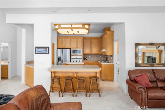 a kitchen with stainless steel appliances granite countertop a sink a stove and refrigerator