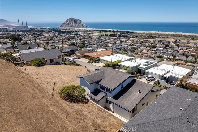 an aerial view of a house with a ocean view