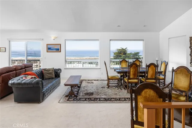 a living room with furniture a window and gym equipment