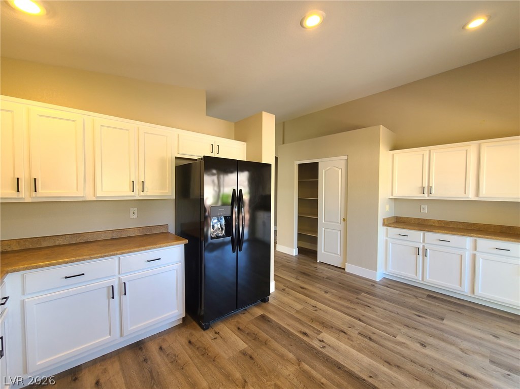 2278 Chestnut Ranch Avenue Henderson, NV 89052 - Photo 8 of 18 A well-lit kitchen featuring clean white cabinetry.
