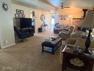 17230 Iron Springs Road Munds Park, AZ 86017 - Photo 11 of 42 a living room with furniture a flat screen tv and a floor to ceiling window
