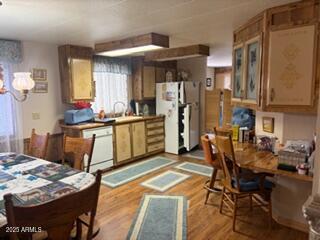 17230 Iron Springs Road Munds Park, AZ 86017 - Photo 17 of 42 a kitchen with stainless steel appliances granite countertop a stove top oven a dining table and chairs with wooden floor