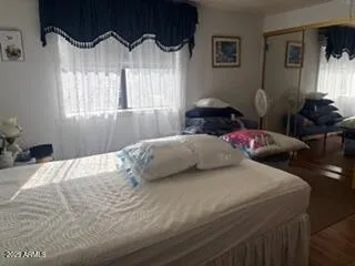 a bedroom with a bed and glass window