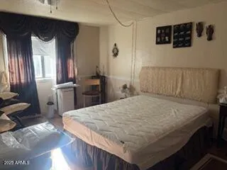 a bed sitting in a bedroom next to a window