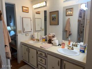 17230 Iron Springs Road Munds Park, AZ 86017 - Photo 31 of 42 a bathroom with double vanity sinks a vanity and a mirror