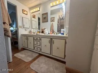 a bathroom with a double vanity sink and mirror